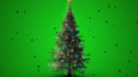 animación de nieve cayendo sobre el árbol de navidad sobre un fondo verde