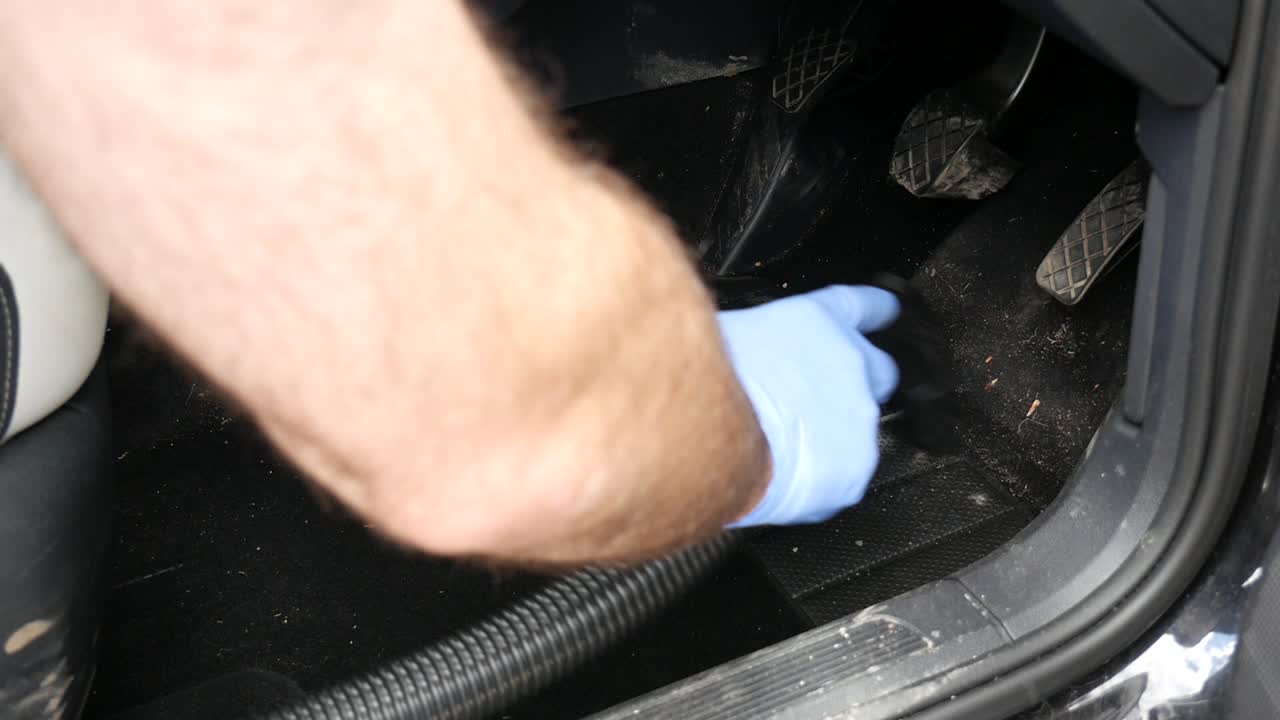 Hovering dirty car interior carpet