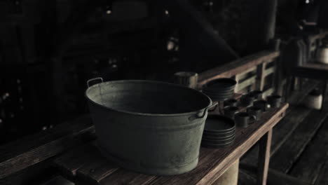 old metal bucket on a wooden table in a rustic setting