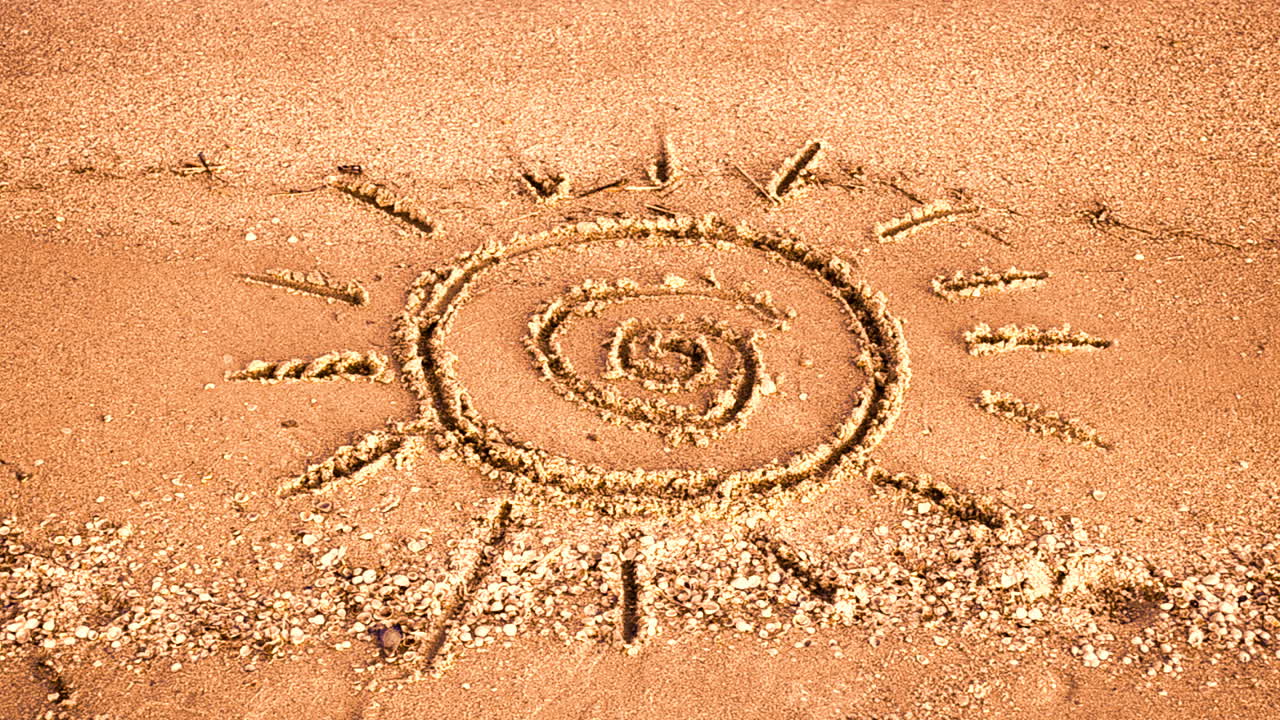 Sun drawing on the beach. Beach and drawing
