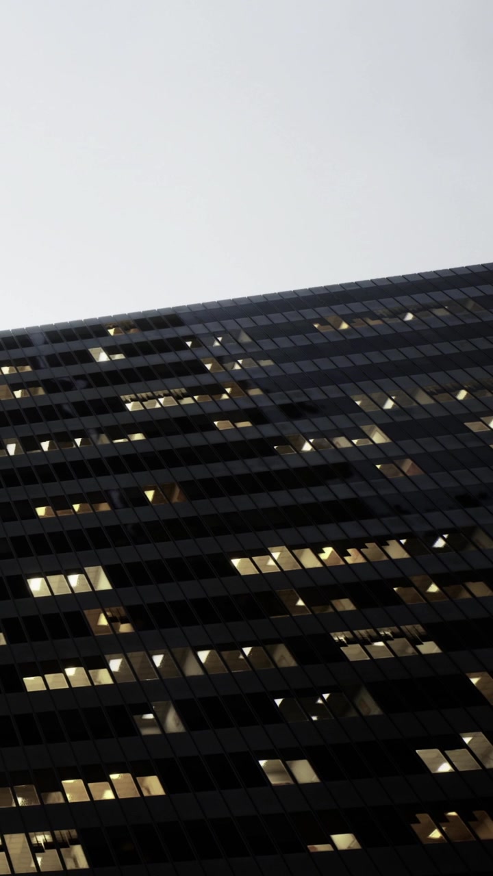 City skyline at dusk with glowing windows creating a vibrant tapestry