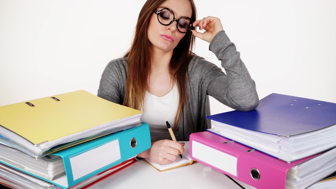 Woman sitting at desk in office working 4K