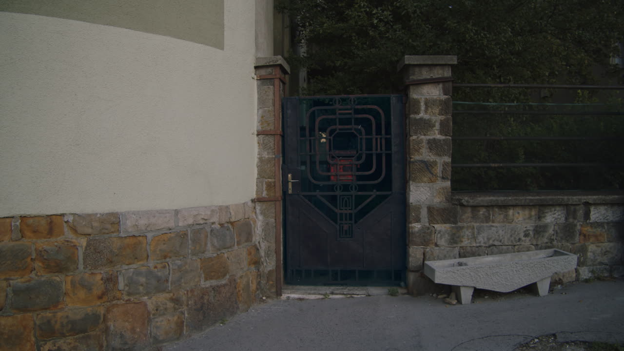 Iron gate, entrance to the courtyard. Establishing scene
