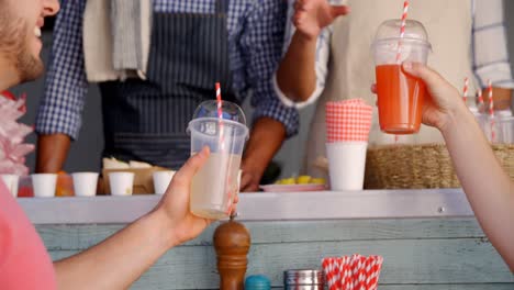 Smiling-waiter-taking-order-from-couple