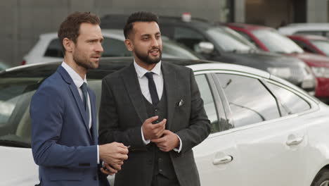 business partners talking in parking lot