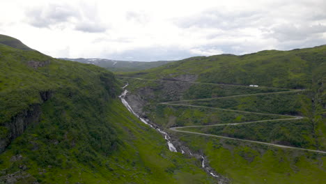 Holesvingane-hairpin-turns-on-mountain-pass,-drone-view-of-Sendefossen-falls