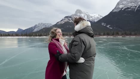 couple skating together on a frozen lake