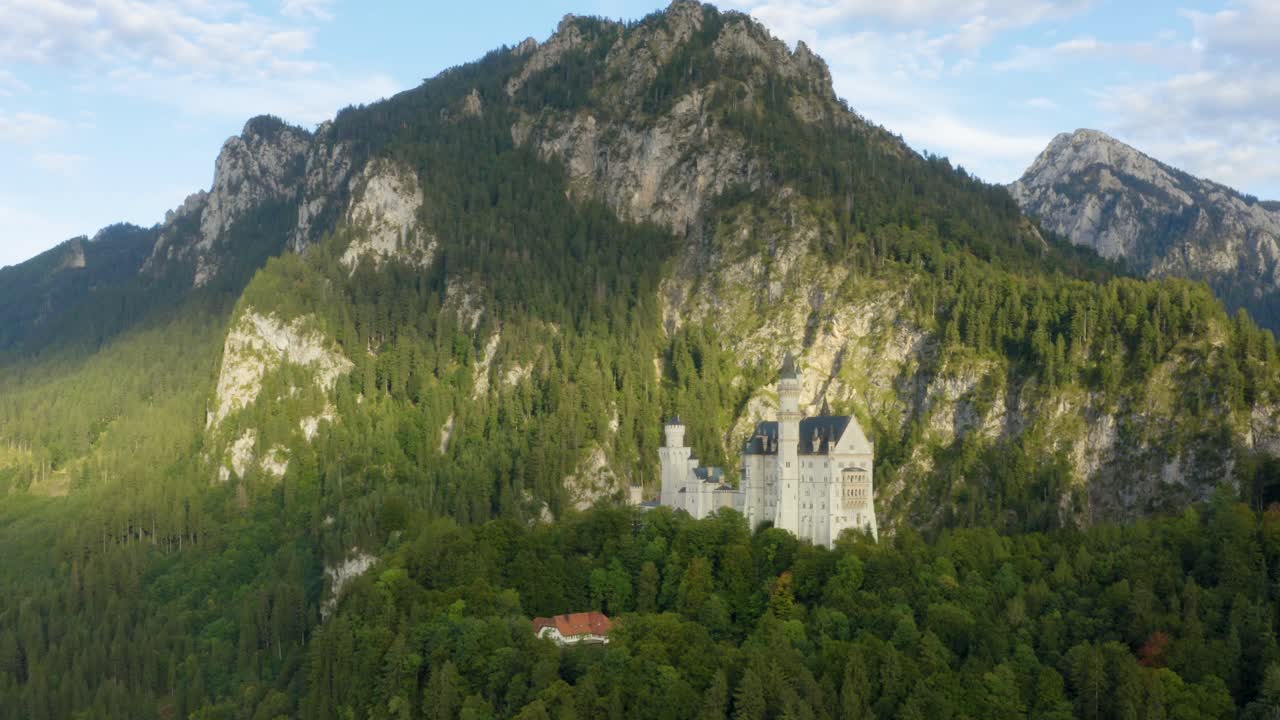 Aerial circle shot of Neuschwanstein Castle, Germany, golden hour