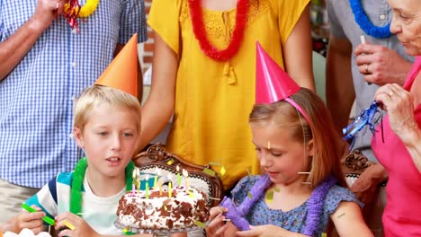 Animation-of-confetti-falling-over-happy-family-at-birthday-party