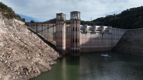 Aerial-rising-of-Sau-dam-in-very-low-water-conditions,-Catalonia,-Spain