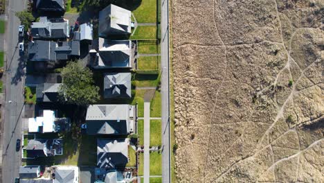 4k aerial drone shot floating over grassland pathway at seaside, oregon beach