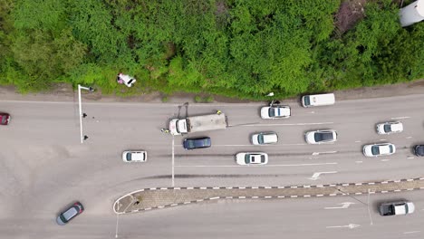 cars swerve around crash accident site blocking traffic on tropical island