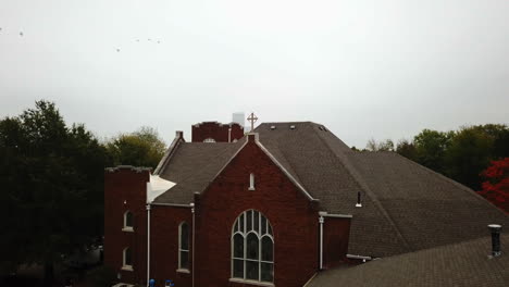 Static-aerial-shot-of-an-American-church-with-a-cross-on-top