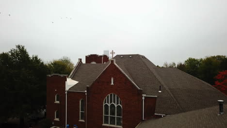 static aerial shot of an american church with a cross on top