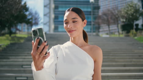 girl blogger recording video content standing street closeup. woman videocalling