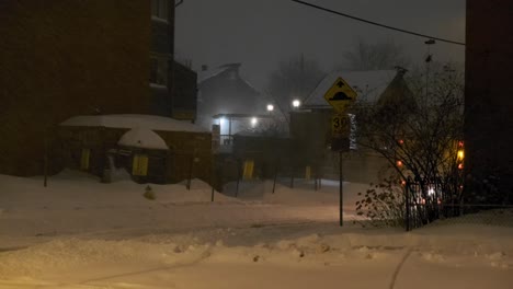 A-large-snow-removal-truck-plows-through-the-streets-of-Ottawa,-Ontario,-Canada-during-a-heavy-snow-storm