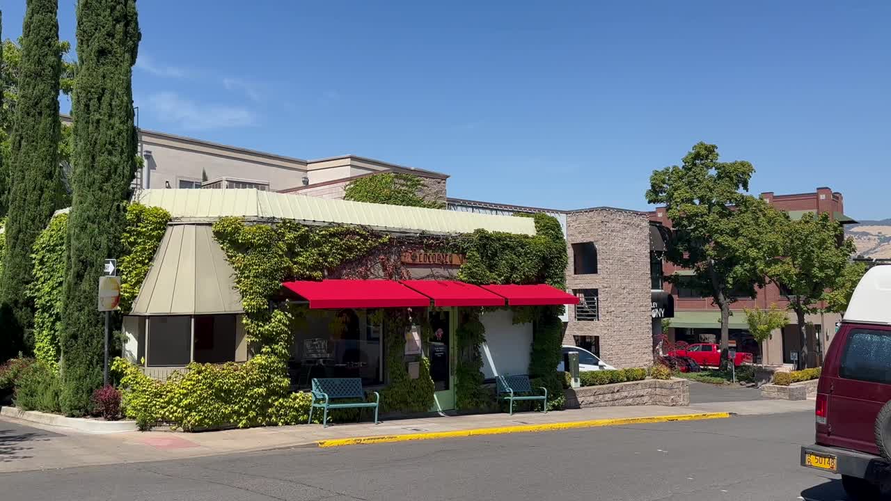 Shopfront of Festive European-style Restaurant Decorated With Lush Green Vines In Ashland, Oregon. wide static shot