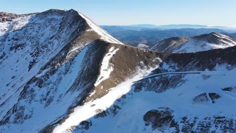 Close-flight-over-snow-capped-peaks-of-rocky-mountains-in-Ski-resort-in-Pyrenees