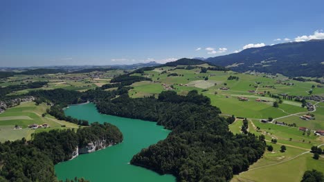 greyerzersee lake gruyère region artificial reservoir aerial drone switzerland valley landscape