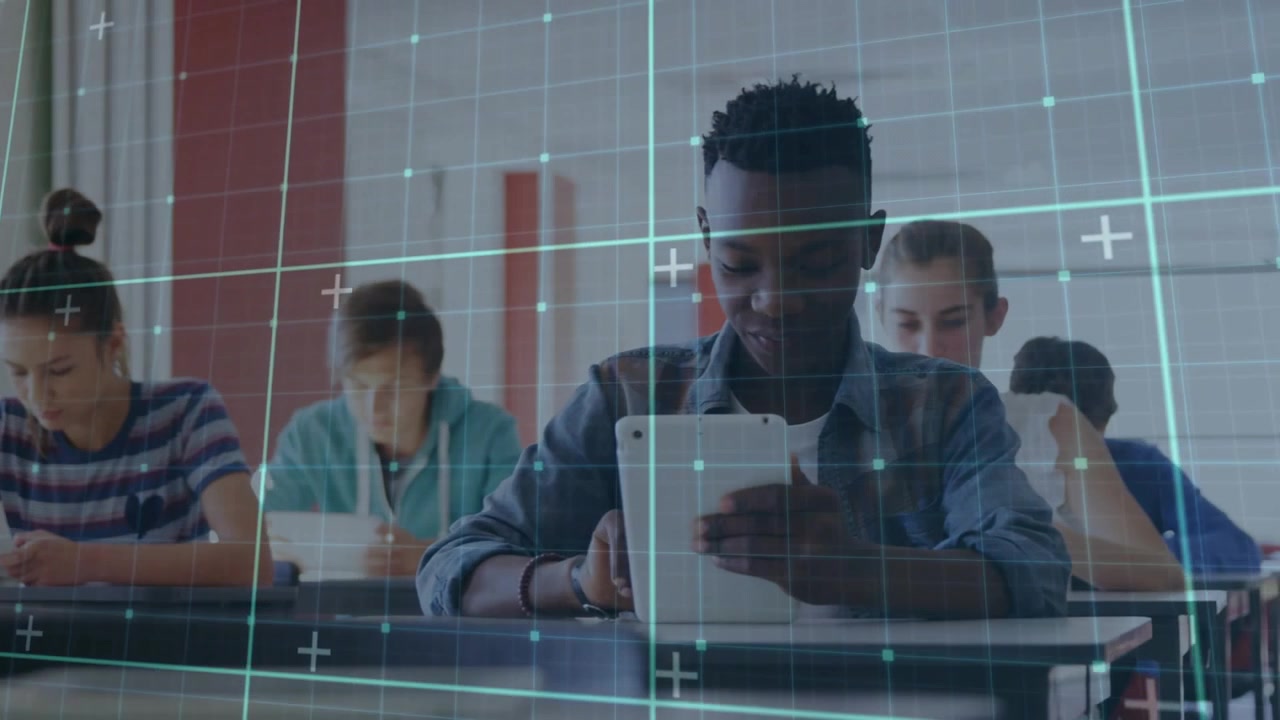 Camera panning row, students writing, black boy tapping tablet under blue grid accessing study app