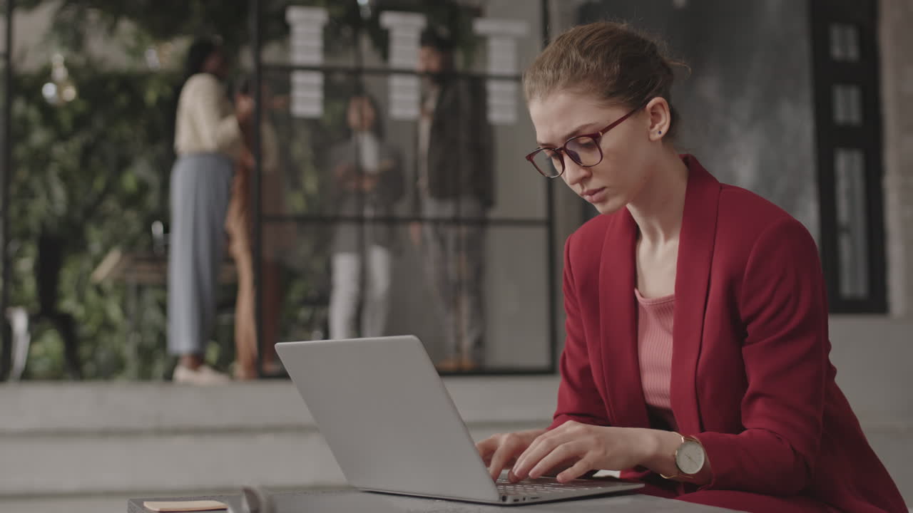 Anxious Woman Using Computer in Office