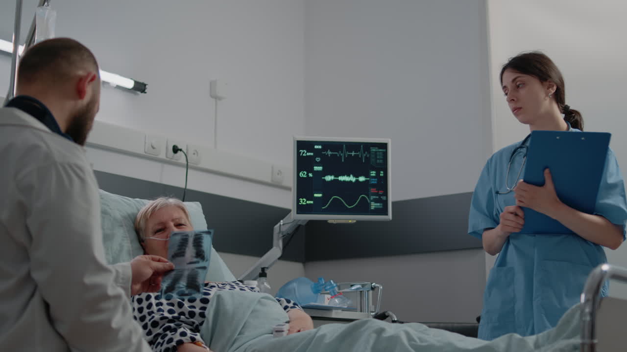 Doctor pointing at x ray scan for consultation with sick patient