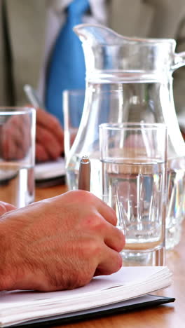 business people taking notes at a meeting