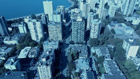 vancouver english bay aerial reverse reveal flight overlooking west end residential community high rise buildings schools lush green trees, beaches, waterfront, quiet post covid19 after math new life