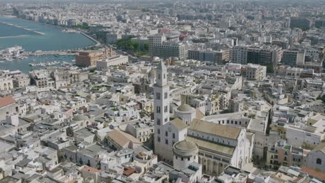 aerial tracking shot that flies in towards the church spire on the basilica cattedrale metropolitana primaziale san sabino in bari, italy