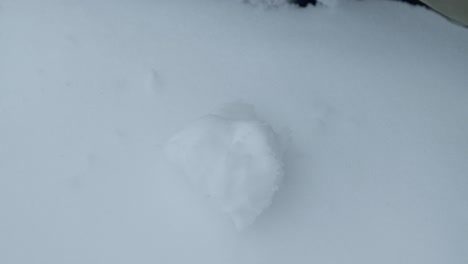 slowmotion closeup of preparing pile of snowballs with black gloves