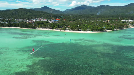 kitesurfers on blue lagoon of koh phangan on a summer day in thailand