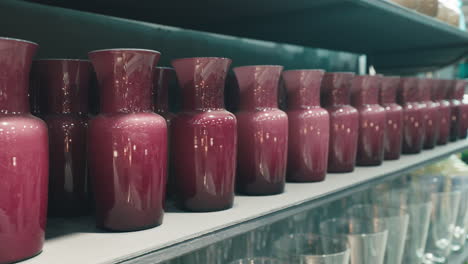 purple glass vases on a shelf