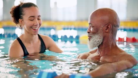 senior man and young woman doing water aerobics in a pool