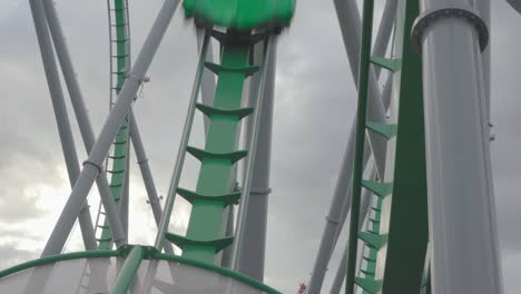 People-having-fun-riding-a-roller-coaster-in-a-themepark