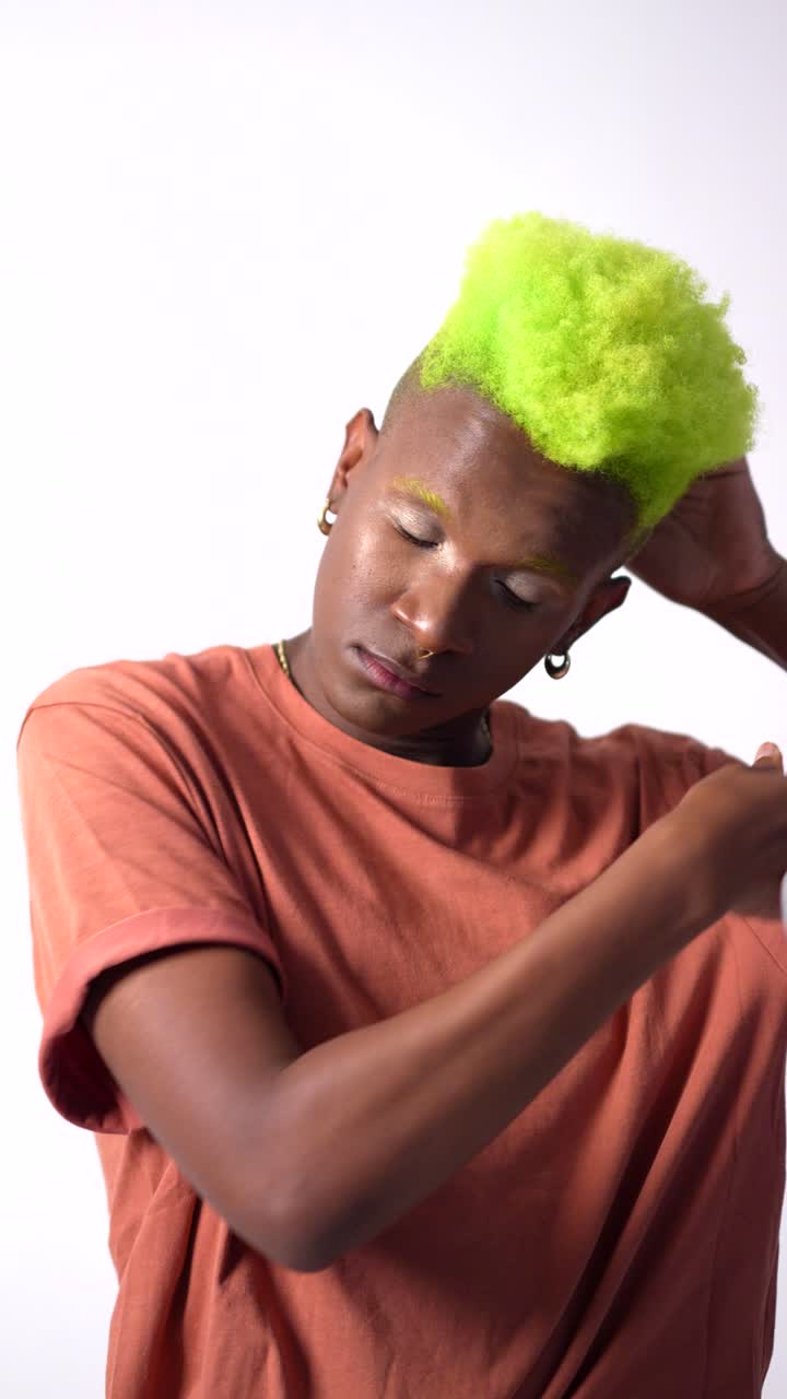 Man with green hair and orange shirt