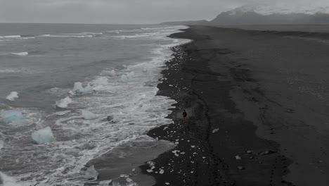 Slow-motion-drone-shot-flying-back-along-the-beach-front