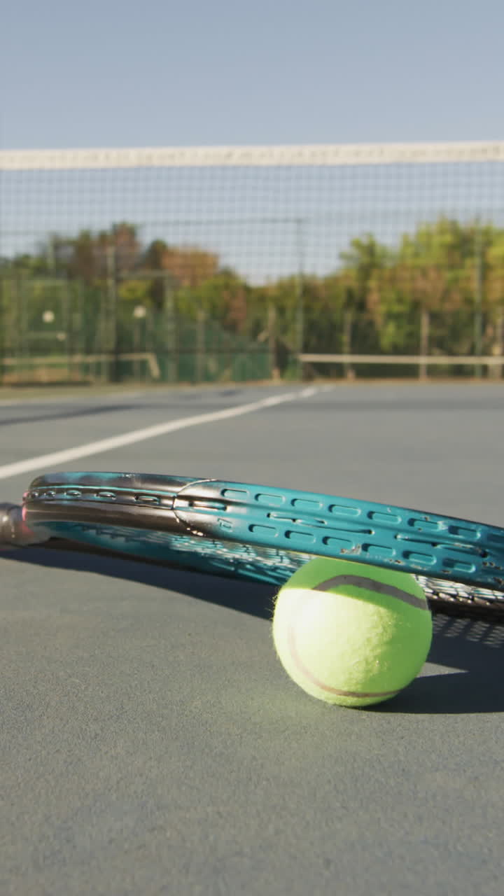 Video of tennis ball and racket lying on tennis court