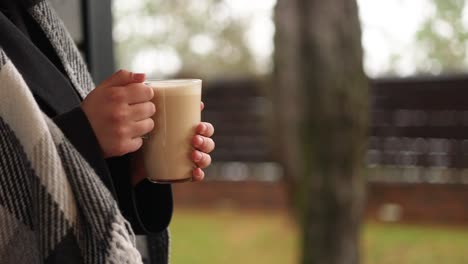 woman enjoying a latte outdoors in autumn