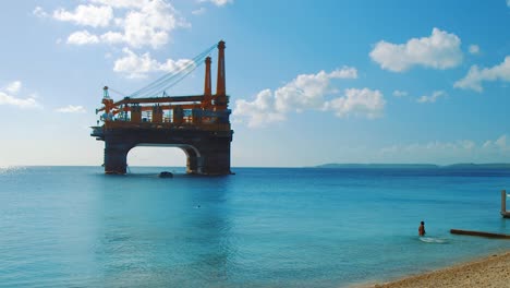 A-Wonderful-Scenery-Of-Gretha-Drilling-Platform-in-Boka-Sami,-Curacao-With-Cloudy-Blue-Sky-Above---Wide-Shot