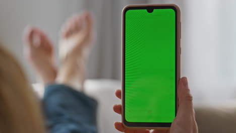 user finger swiping chromakey cellphone home closeup. girl hands scrolling phone