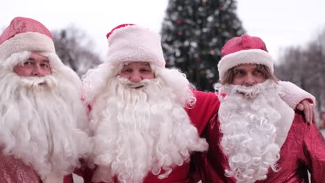 three santa clauses make a photo shoot near the christmas tree three santa clauses make a photo shoot near the christmas tree festive mood in the new 2023 fabulous and christmas spirit in the frame