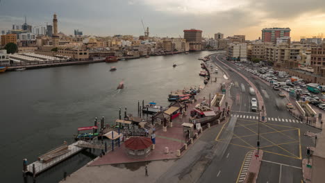 timelapse of old dubai creekside with traditional abras and buildings.