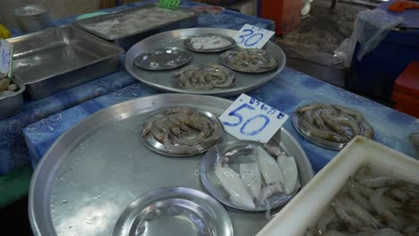 squid shrimp prawn for sale at local street seafood food market in plates