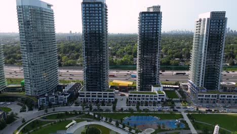 housing development construction crane with townhouses and high-rise condo towers near highway