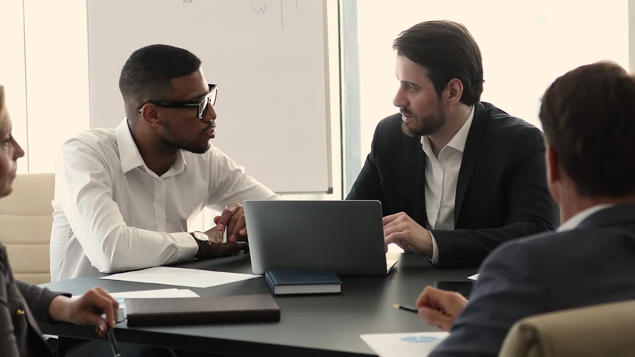 Group of serious multiethnic businesspeople negotiating, solve business in office