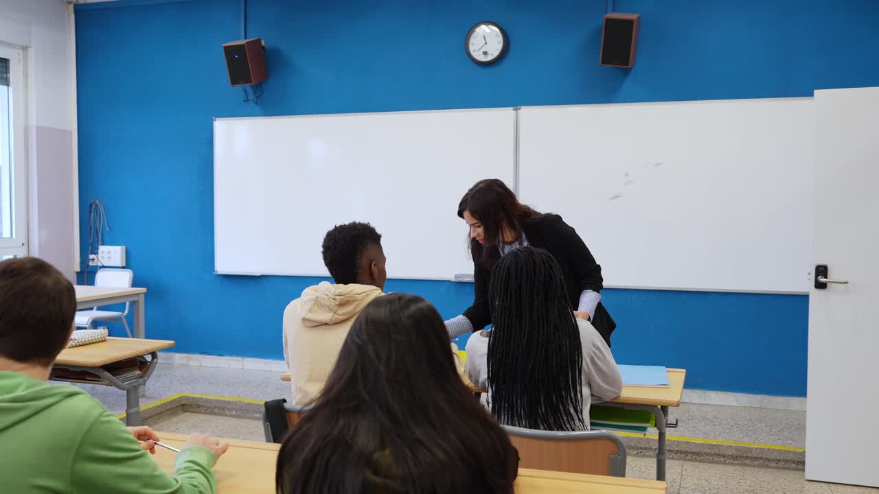 Teacher interacting with students in a modern classroom