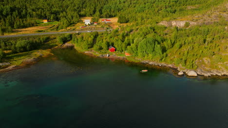 Boat-sheds-and-small-boat-in-Efjorden,-Norway