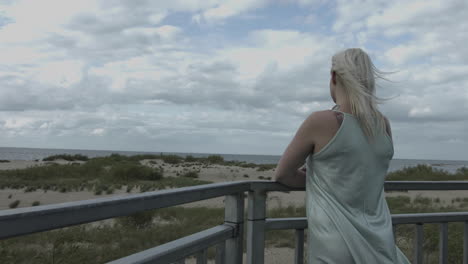 a young lonely woman is standing outside, she is grief-stricken