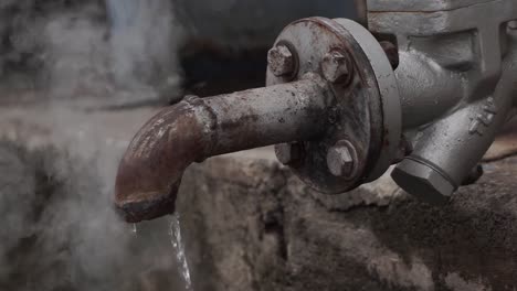 rusty pipe and steam then dripping water with dark and black atmosfer of industrial