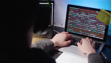 young caucasian man in headphones typing on laptop keyboard